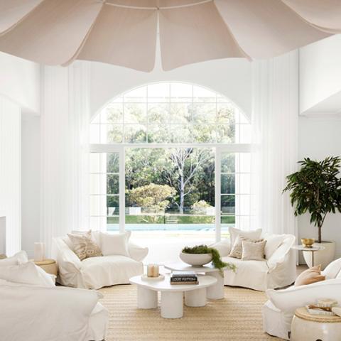 High key living room with an arched window.